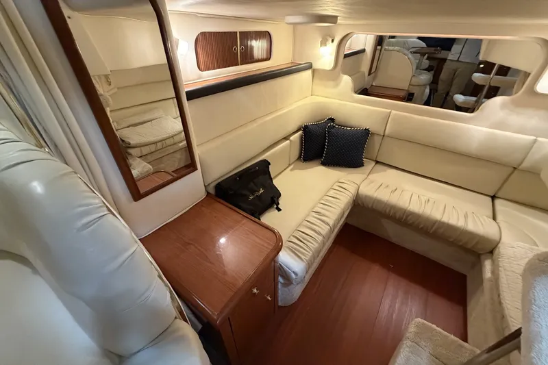 Slide: The Image of Luxurious interior of 1999 Sea Ray 340 Sundancer yacht with cream seating and wooden accents. - 37