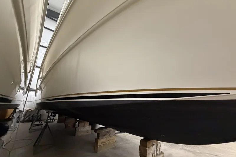 Slide: The Image of 1999 Sea Ray 340 Sundancer boat hull in storage, supported by blocks. - 9