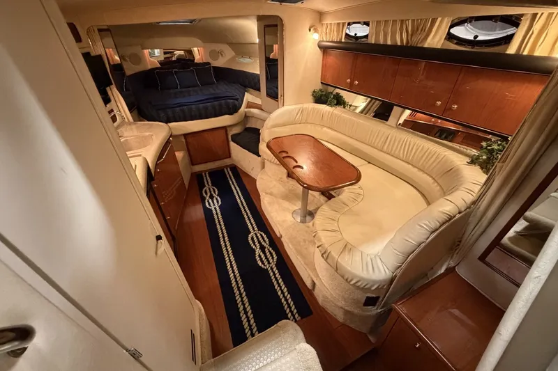 Slide: The Image of Luxurious interior of a 1999 Sea Ray 340 Sundancer yacht with elegant seating and wood finishes. - 23