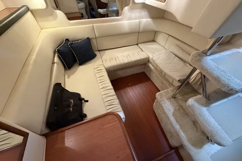 Slide: The Image of Interior of 1999 Sea Ray 340 Sundancer yacht with plush seating and carpeted stairs. - 36