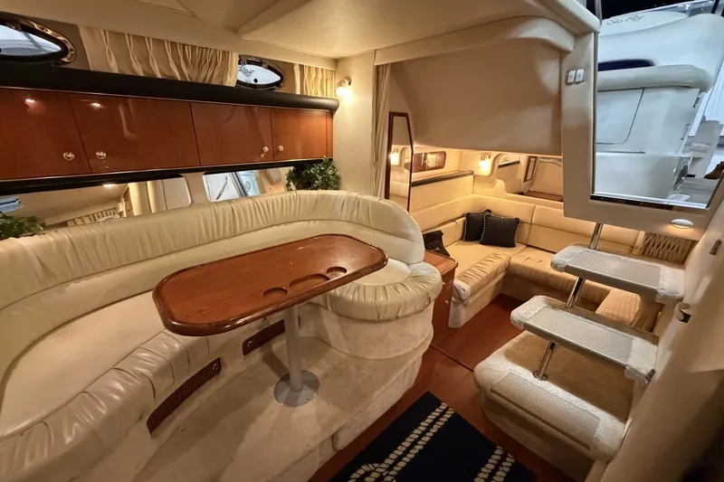 Slide: The Image of Luxurious interior of a 1999 Sea Ray 340 Sundancer yacht with elegant seating and wooden accents. - 26