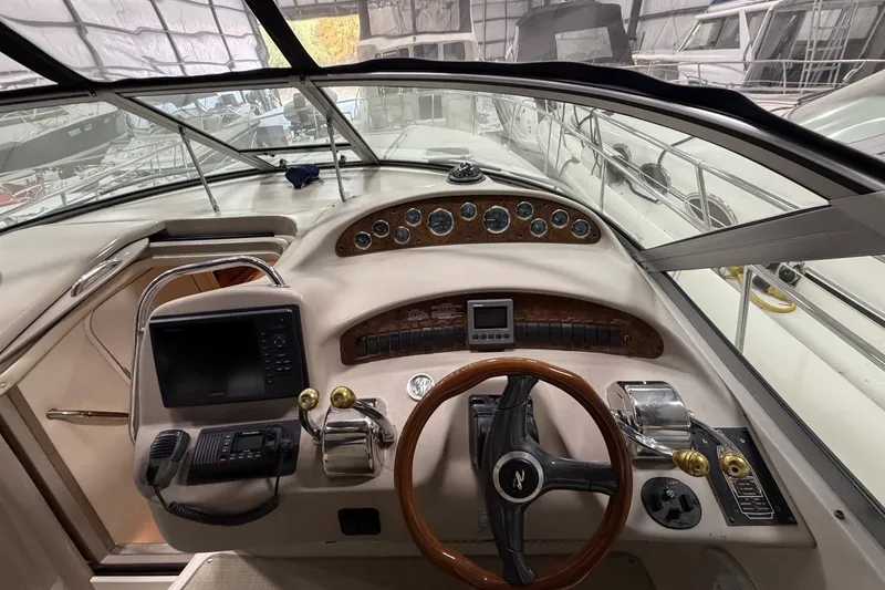 Slide: The Image of Cockpit of a 1999 Sea Ray 340 Sundancer with steering wheel and control panel. - 21