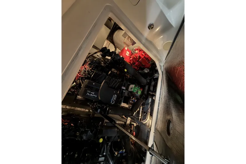 Slide: The Image of Engine compartment of 1999 Sea Ray 340 Sundancer boat, showcasing mechanical components. - 41
