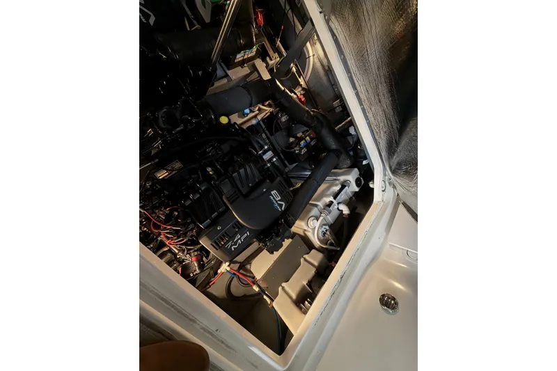 Slide: The Image of Engine compartment of a 1999 Sea Ray 340 Sundancer boat, showcasing mechanical components. - 40