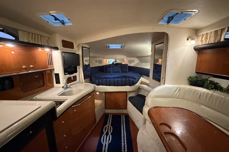 Slide: The Image of Luxurious interior of a 1999 Sea Ray 340 Sundancer yacht with cozy seating and modern amenities. - 24