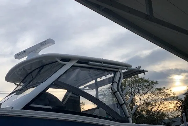 Slide: The Image of 2021 World Cat 280 DC-X boat with Garmin radar, under cloudy sky at sunset. - 26