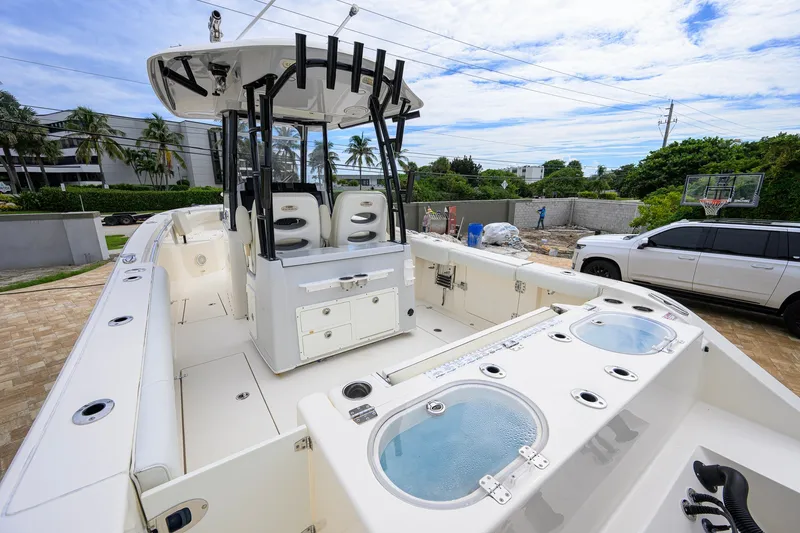 Slide: The Image of 2019 Cobia 301 Center Console boat with spacious deck and modern amenities. - 18