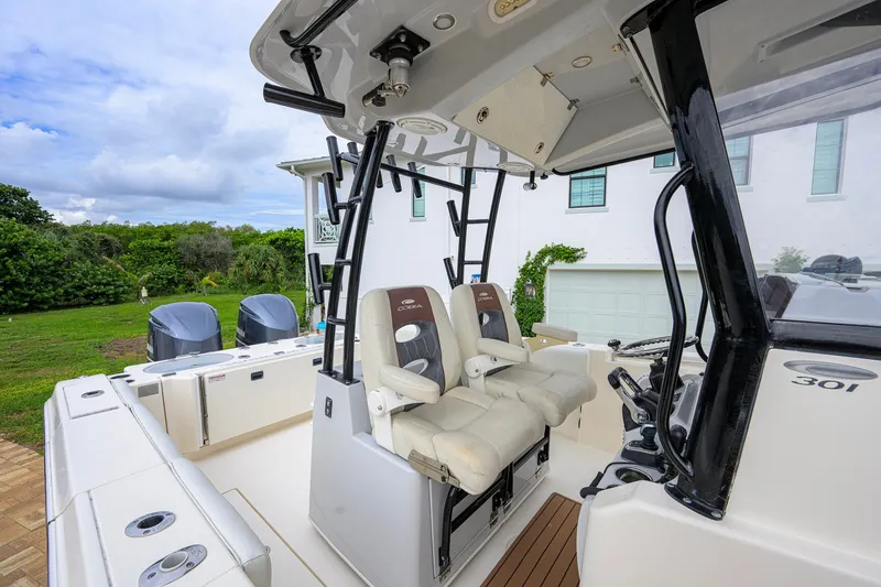Slide: The Image of 2019 Cobia 301 Center Console boat with dual engines and comfortable seating. - 38