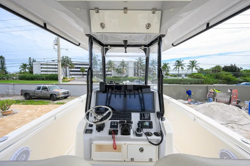 Slide: The Image of 2019 Cobia 301 Center Console boat interior with steering wheel and control panel. - 3