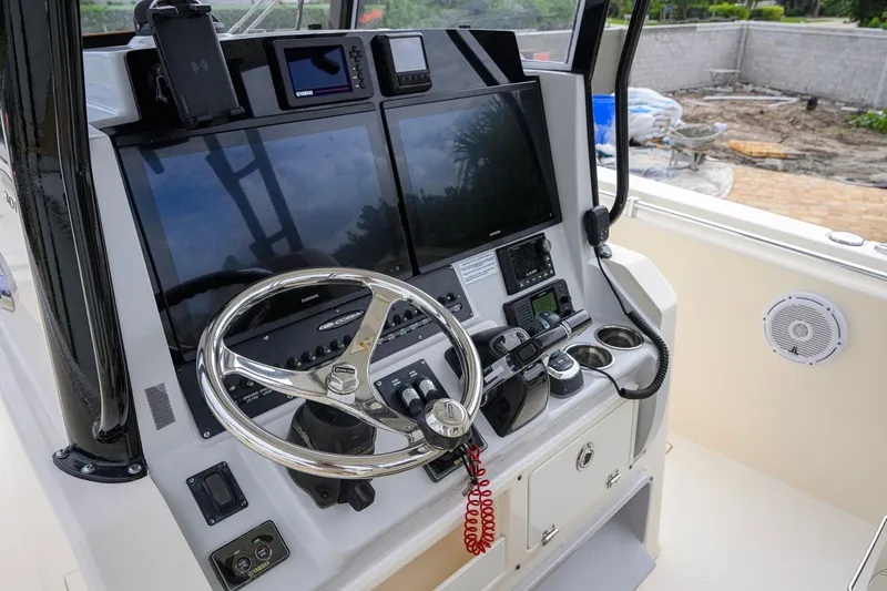 Slide: The Image of 2019 Cobia 301 Center Console helm with advanced navigation and control systems. - 40