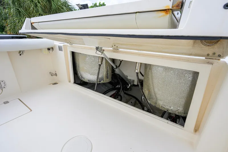 Slide: The Image of Open storage compartment on a 2019 Cobia 301 Center Console boat, showing internal components. - 24