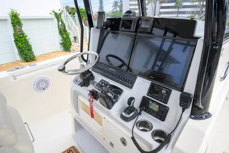 Slide: The Image of 2019 Cobia 301 Center Console boat dashboard with modern navigation equipment. - 35