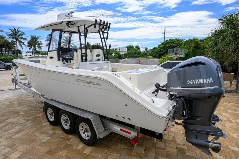 Slide: The Image of 2019 Cobia 301 Center Console boat with Yamaha engine on a trailer. - 11