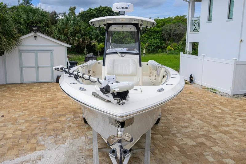 Slide: The Image of 2019 Cobia 301 Center Console boat with Garmin equipment, parked on a paved driveway. - 9