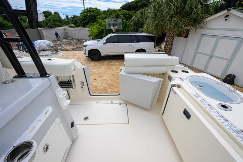 Slide: The Image of 2019 Cobia 301 Center Console boat interior with a white SUV in the background. - 21
