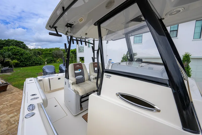 Slide: The Image of 2019 Cobia 301 Center Console boat with dual seats and sleek design. - 37