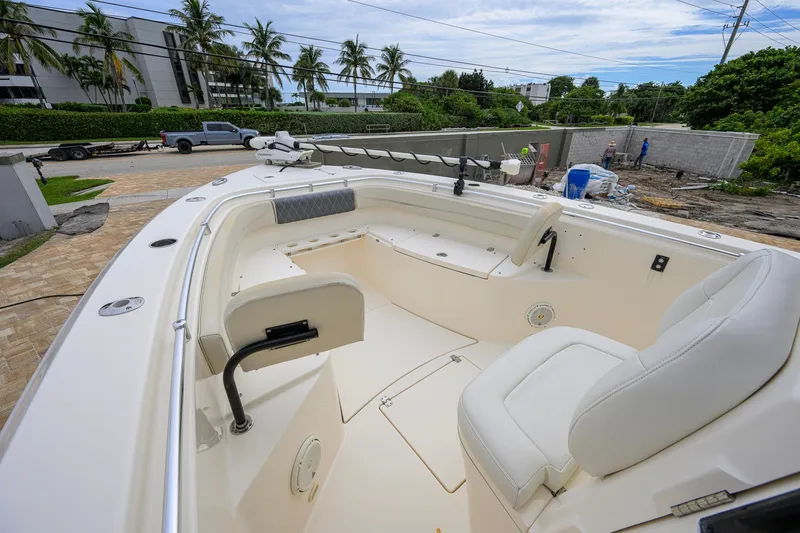 Slide: The Image of 2019 Cobia 301 Center Console boat interior with seating and fishing equipment. - 51