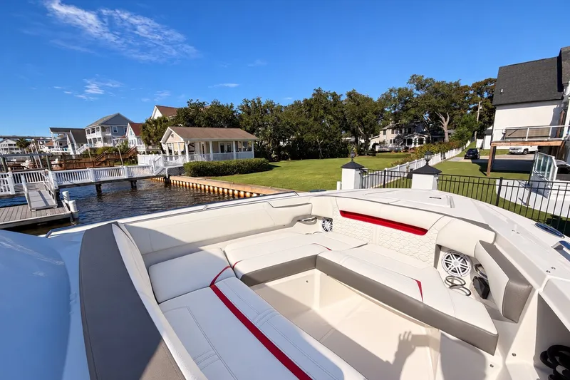 Slide: The Image of 2023 Tiara Yachts 34 LS luxury boat docked near waterfront homes. - 19