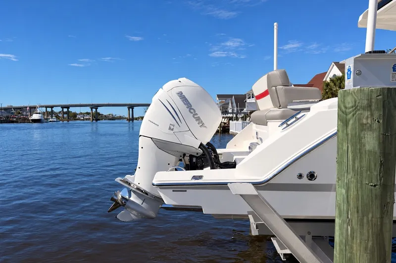 Slide: The Image of 2023 Tiara Yachts 34 LS with Mercury outboard engine docked by the water. - 18