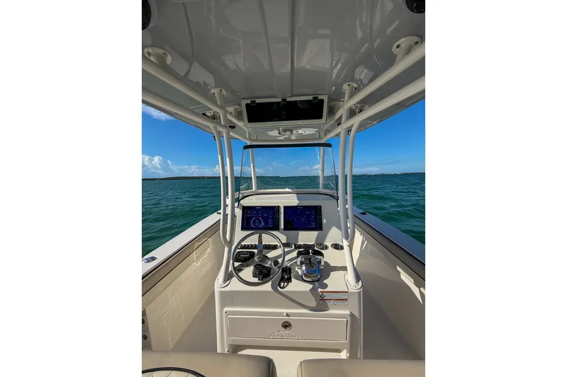 Slide: The Image of 2021 Sea Chaser 30 HFC CC boat dashboard with ocean view and clear blue sky. - 15