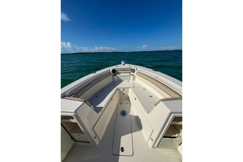 Slide: The Image of 2021 Sea Chaser 30 HFC CC boat on open water under clear blue sky. - 16