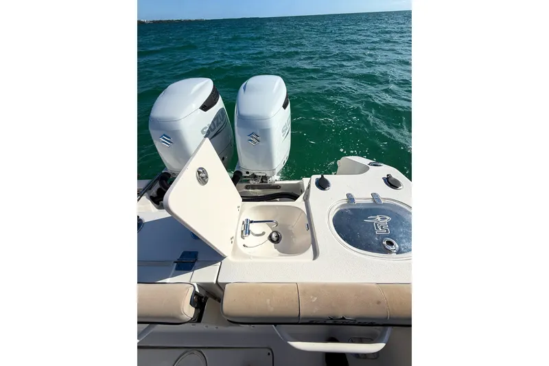 Slide: The Image of 2021 Sea Chaser 30 HFC CC boat with dual Suzuki outboard motors on open water. - 19