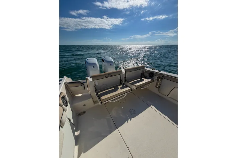 Slide: The Image of 2021 Sea Chaser 30 HFC CC boat on open water, featuring dual engines and seating. - 11