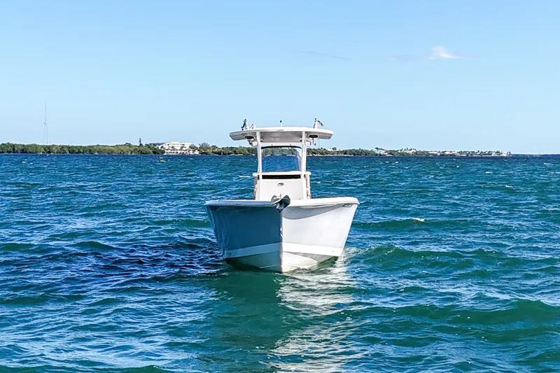 Slide: The Image of 2021 Sea Chaser 30 HFC CC boat on open water, clear sky background. - 2