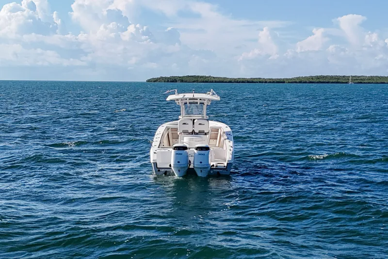 Slide: The Image of 2021 Sea Chaser 30 HFC CC boat on open water, clear sky background. - 3