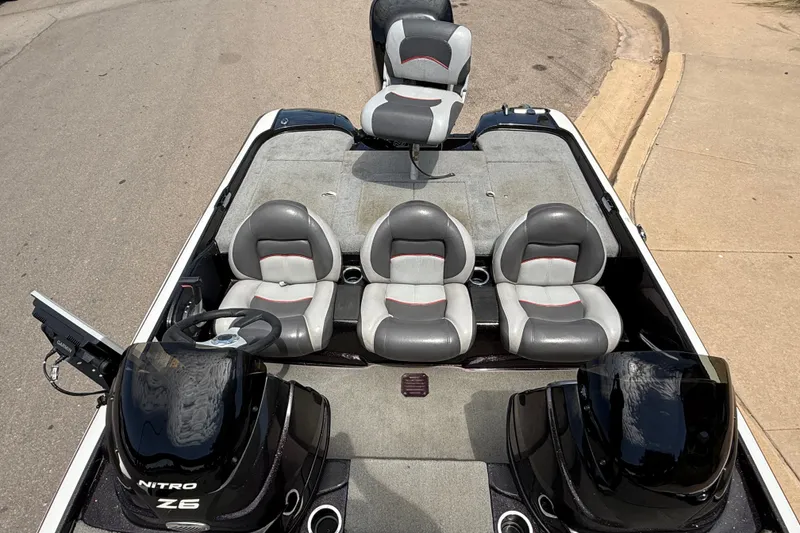 Slide: The Image of 2014 Nitro Z-6 boat interior with gray seats and dual consoles. - 12