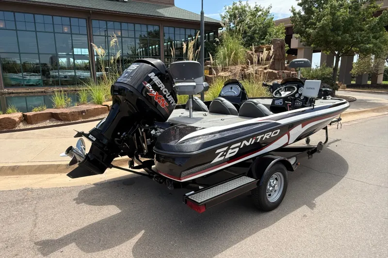 Slide: The Image of 2014 Nitro Z-6 boat with Mercury engine, parked outdoors near a building. - 7