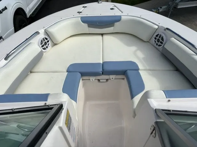Slide: The Image of The 2023 Robalo R207 Dual Console features a spacious, cushioned seating area in the bow. - 8