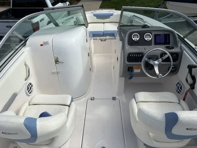 Slide: The Image of The image shows the cockpit of a 2023 Robalo R207 Dual Console boat with white seating. - 9