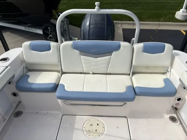 Slide: The Image of The 2023 Robalo R207 Dual Console features a comfortable, cushioned bench seat with blue and white upholstery. - 15