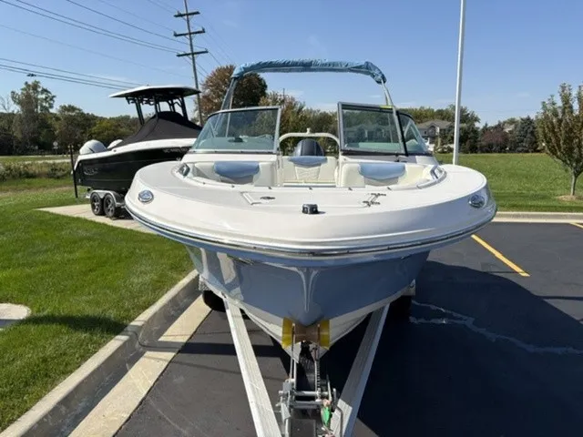 Slide: The Image of A 2023 Robalo R207 Dual Console boat on a trailer, parked in a lot. - 17