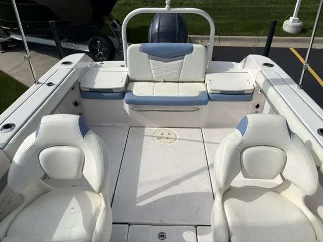 Slide: The Image of The image shows the cockpit of a 2023 Robalo R207 Dual Console boat with white seating. - 12