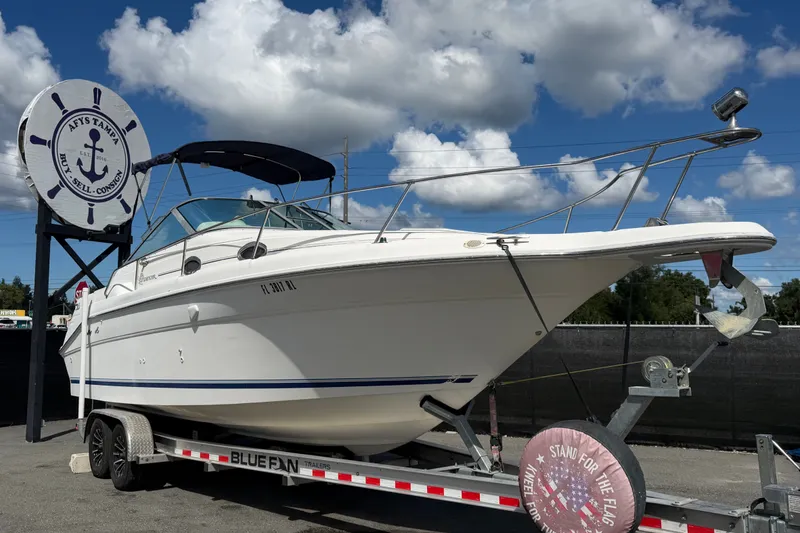 The Image of 1996 Sea Ray 270 Sundancer boat on trailer under blue sky. - 0