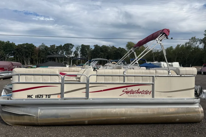 The Image of 2008 Sweetwater Tuscany 1880 pontoon boat with canopy, parked outdoors. - 0