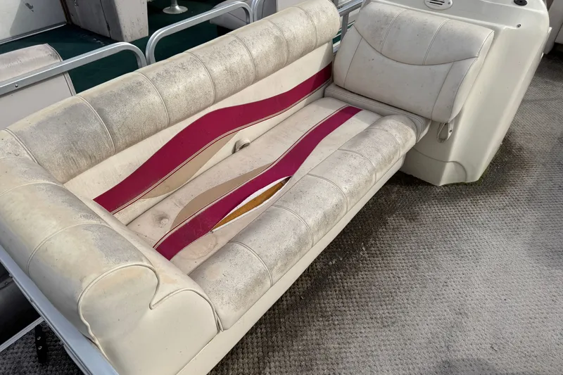 Slide: The Image of Worn Sweetwater Tuscany 1880 boat seat with red accents, showing signs of aging. - 2