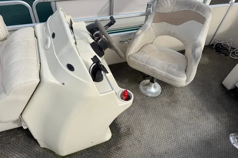 Slide: The Image of Interior of a 2008 Sweetwater Tuscany 1880 boat with steering console and swivel chair. - 5