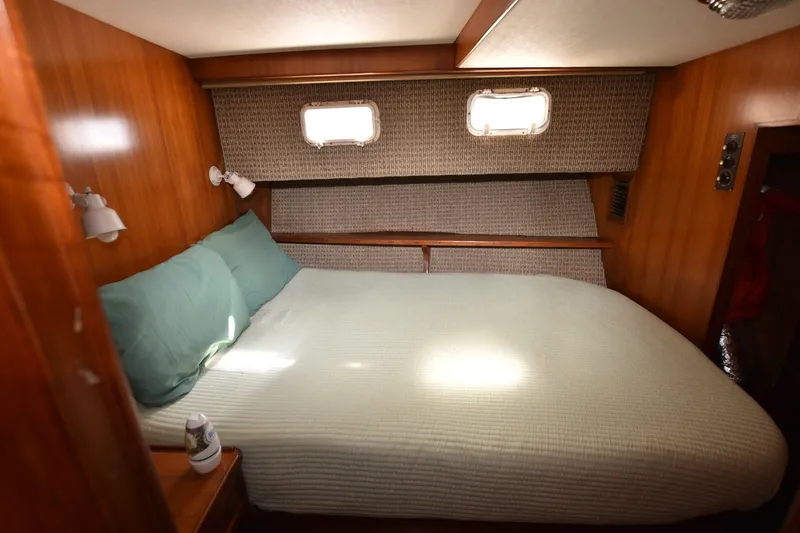 Slide: The Image of Cozy bedroom in 1989 Jefferson Marquessa 52 yacht with wood paneling and natural light. - 13