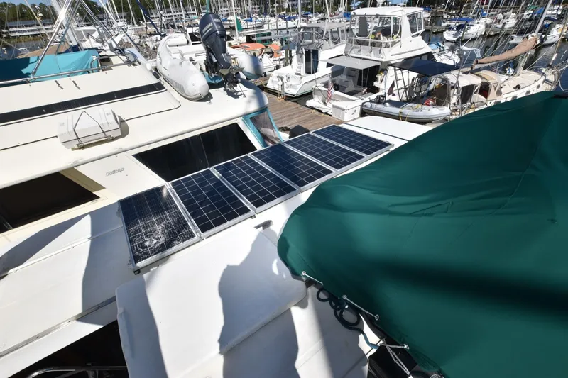 Slide: The Image of 1989 Jefferson Marquessa 52 yacht with solar panels docked at marina. - 38