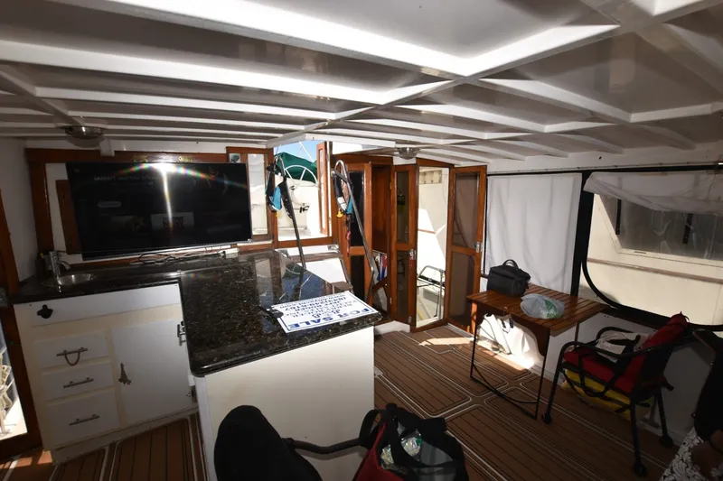 Slide: The Image of Interior of 1989 Jefferson Marquessa 52 yacht with modern amenities and wooden accents. - 30