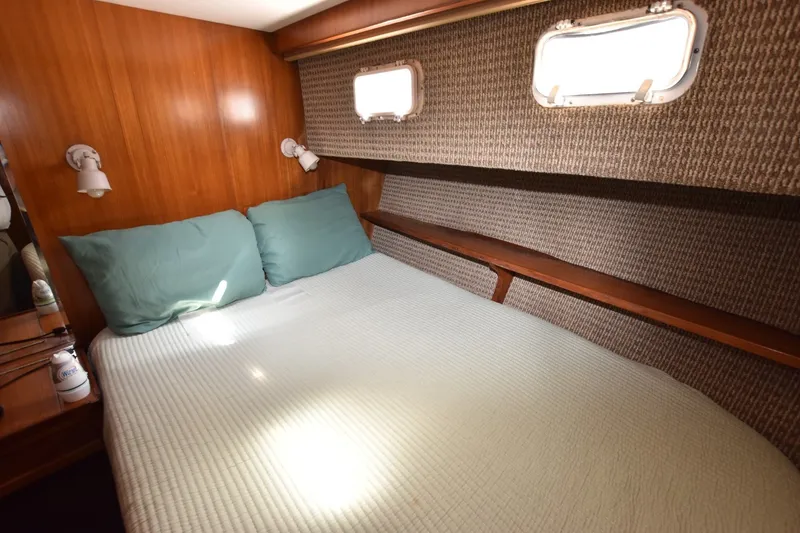 Slide: The Image of Cozy bedroom in 1989 Jefferson Marquessa 52 yacht with wood paneling and porthole windows. - 14