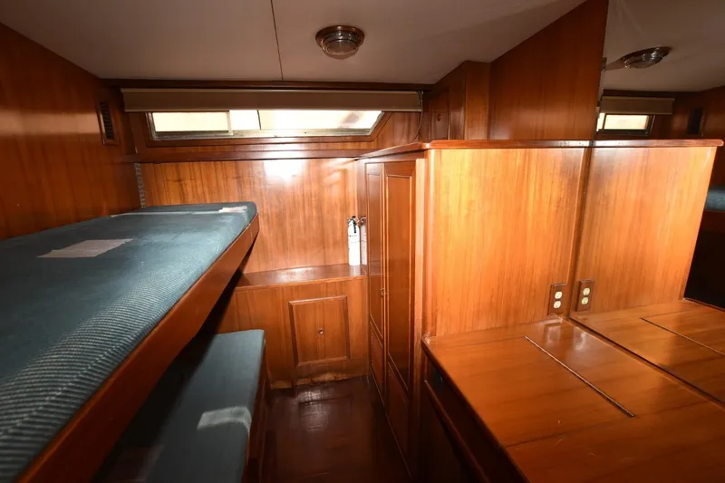 Slide: The Image of 1989 Jefferson Marquessa 52 yacht interior with wooden cabinetry and bunk beds. - 27