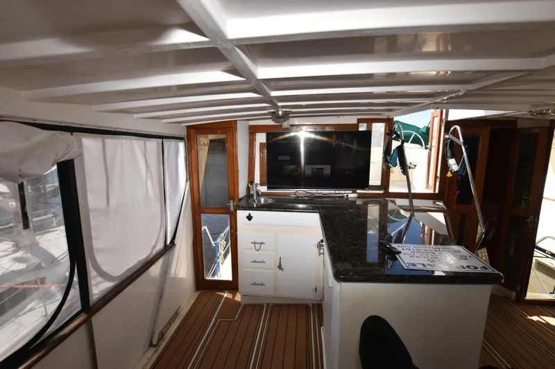 Slide: The Image of Interior of 1989 Jefferson Marquessa 52 yacht with modern amenities and wooden accents. - 29