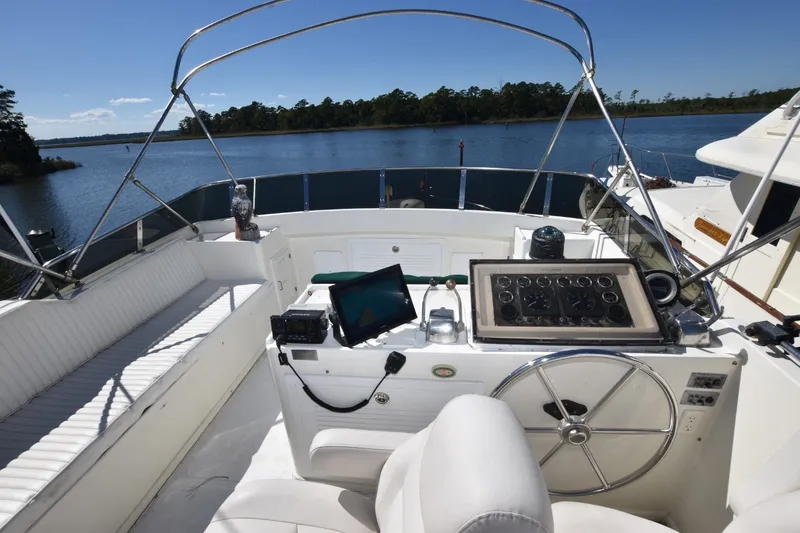 Slide: The Image of 1989 Jefferson Marquessa 52 yacht helm with scenic water view and navigational equipment. - 34