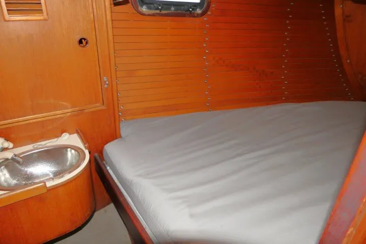 Slide: The Image of 1984 Wauqueize Hood 38 MK II yacht interior with wooden paneling and compact sink. - 23