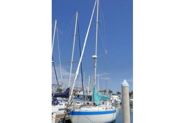 Slide: The Image of Sailboat Wauqueize Hood 38 MK II, 1984 model, docked at marina under clear blue sky. - 57