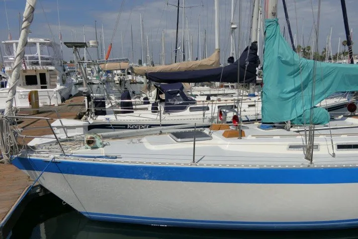 Slide: The Image of 1984 Wauqueize Hood 38 MK II sailboat docked in a marina with other vessels. - 49